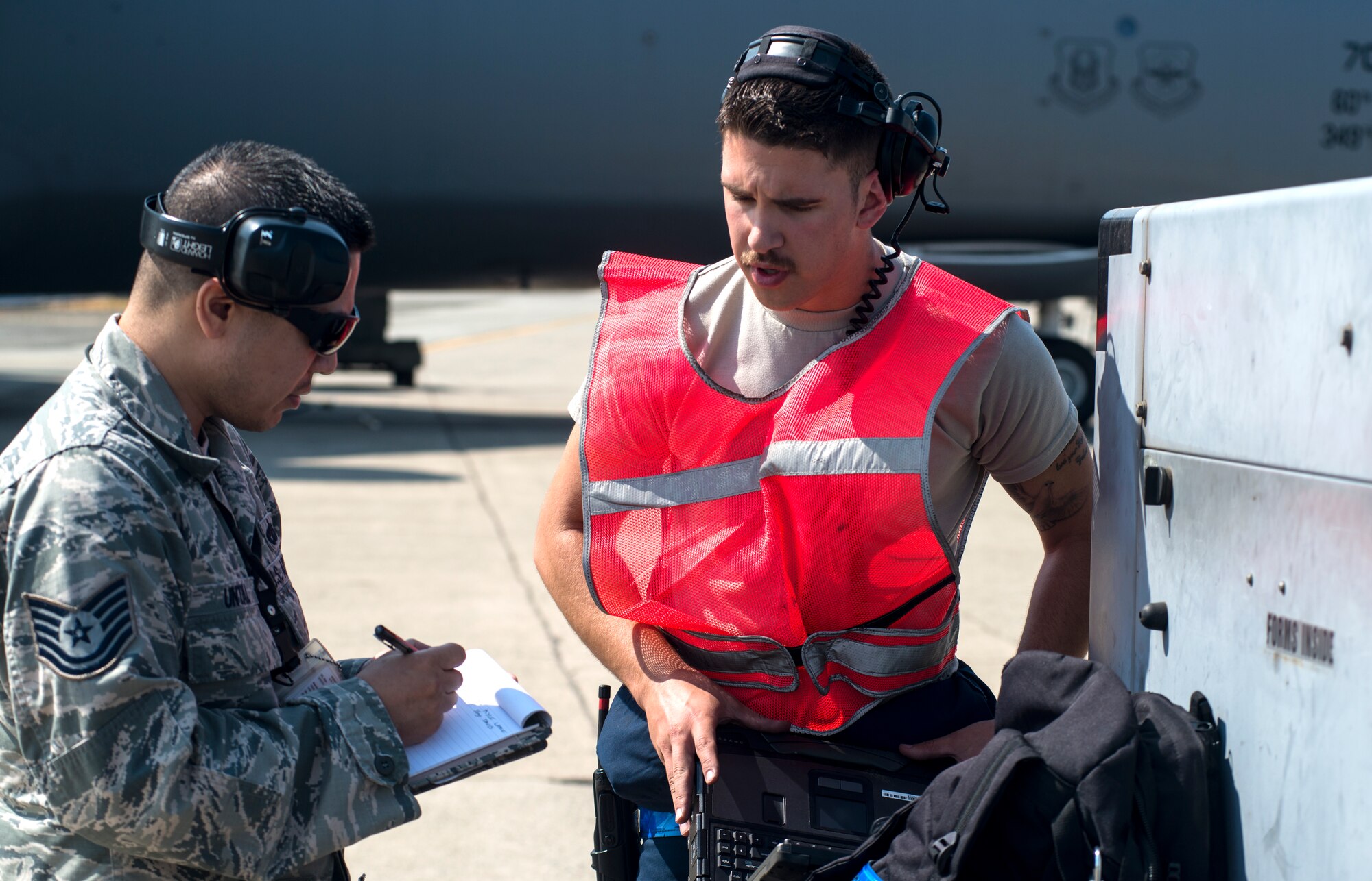 Tech. Sgt. Antonio Untal, 349th Aircraft Maintenance Squadron crew chief, debriefs Senior Airman Kyle Lake, 60th AMXS crew chief, after launching a C-5M Super Galaxy on Aug. 11, 2018, at Travis Air Force Base, Calif. The 349th and 60th AMXS work together to launch aircraft in a seemless active duty and Air Force Reserve integration.