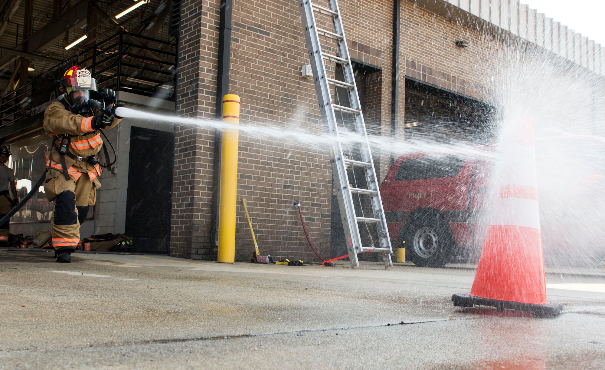 U.S. Air Force Senior Airman Christopher Moretto, 20th Civil Engineer Squadron fire protection apprentice, sprays a simulated fire during proficiency training at Shaw Air Force Base, S.C., Aug. 14, 2018.
