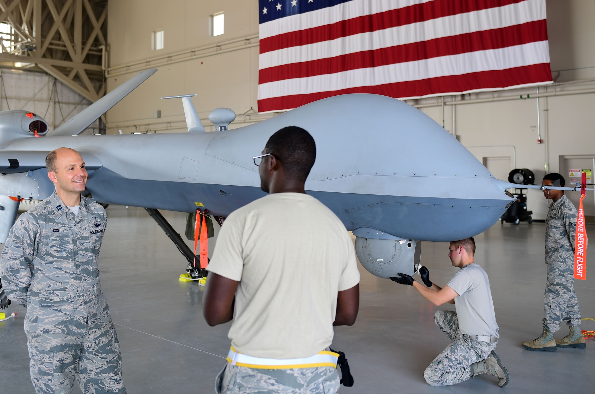 Chaplain Matthew, 432nd Wing/432nd Air Expeditionary Wing chaplain, speaks with Senior Airman Devin, 432nd Aircraft Maintenance Squadron avionics specialist, in the work center August 10, 2018, at Creech Air Force Base, Nev. Matthew began his 25-year career in the U.S. Army as an infantryman. Through the years he has changed careers multiple times before becoming a U.S. Air Force Chaplain. (U.S. Air Force photo by Senior Airman Christian Clausen)