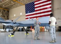 Chaplain Matthew, 432nd Wing/432nd Air Expeditionary Wing chaplain, speaks with Senior Airman Devin, 432nd Aircraft Maintenance Squadron avionics specialist, in the work center August 10, 2018, at Creech Air Force Base, Nev. Matthew spent 22 years in the U.S. Army as an infantryman, honor guardsman, and Apache helicopter pilot prior to becoming a U.S. Air Force Chaplain. He now leverages his combat experience to further help combat Airmen. (U.S. Air Force photo by Senior Airman Christian Clausen)