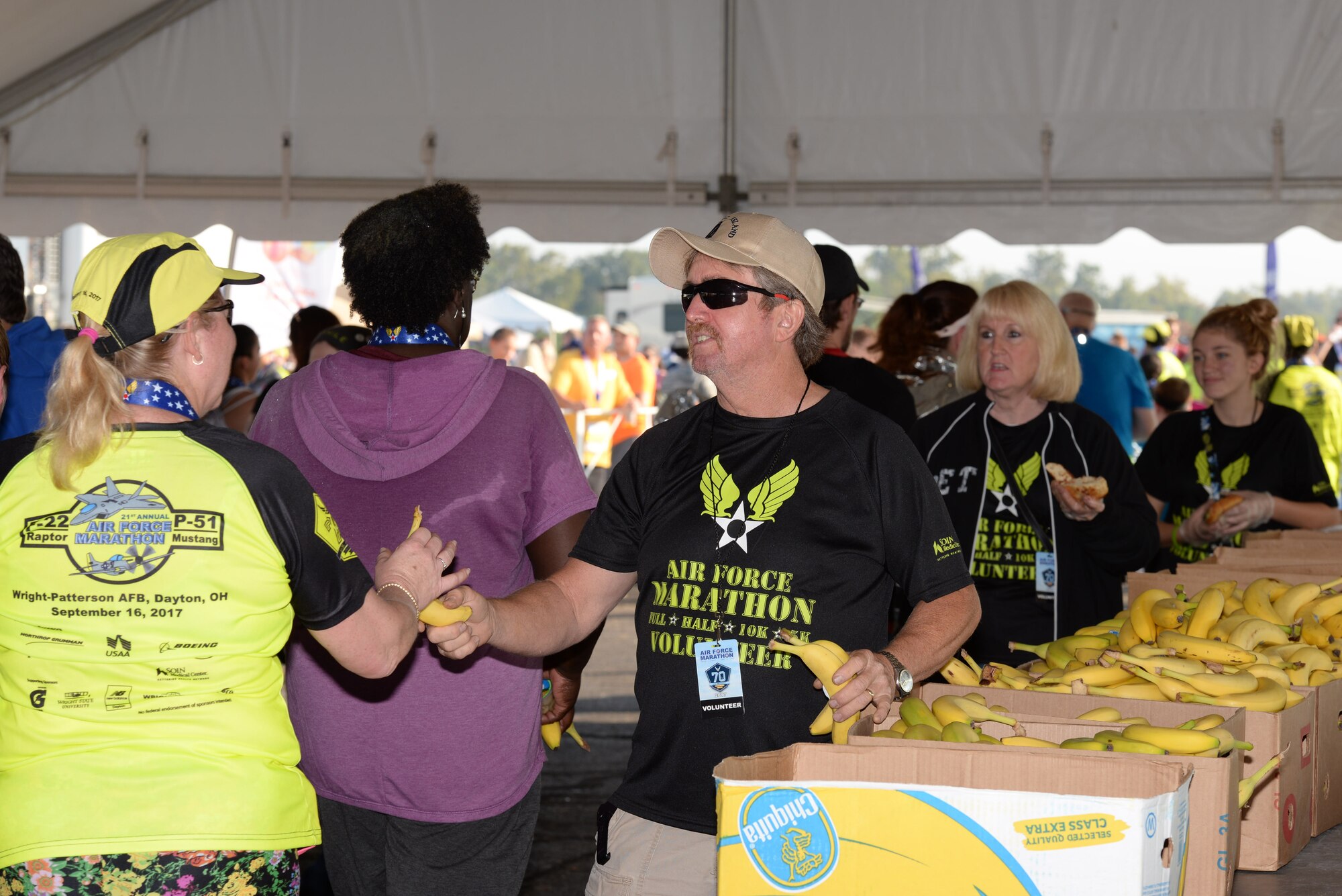 Air Force Marathon volunteers hand out bananas to runners after the finish line Sept. 16, 2017.
