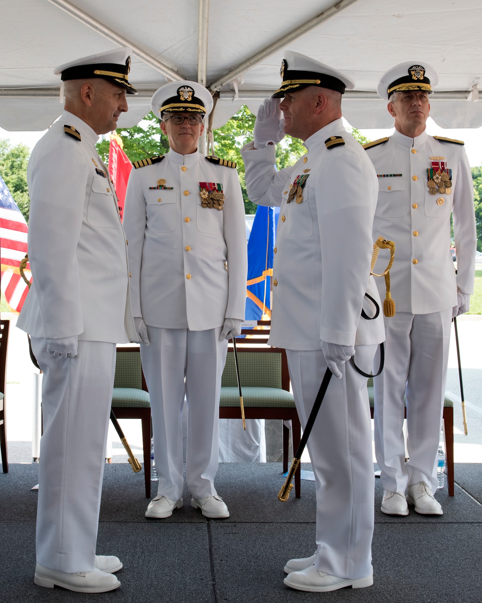 Captain Rees Lee (front left) is relieved by Captain Matthew Hebert (front right) who assumed the role of commanding officer, Naval Medical Research Unit Dayton, August 6.