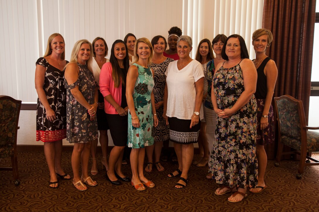 Mrs. D'Arcy Neller (center), wife of U.S. Marine Corps Gen. Robert B. Neller, Commandant of the Marine Corps, poses for a group photo with spouses of unit leaders from Marine Corps Base Hawaii (MCBH) after a luncheon at the Officers' Club, MCBH, Aug. 7, 2018. Mrs. Neller focused the discussions on family readiness, morale and the welfare of families. (U.S. Marine Corps photo by Sgt. Jesus Sepulveda Torres)