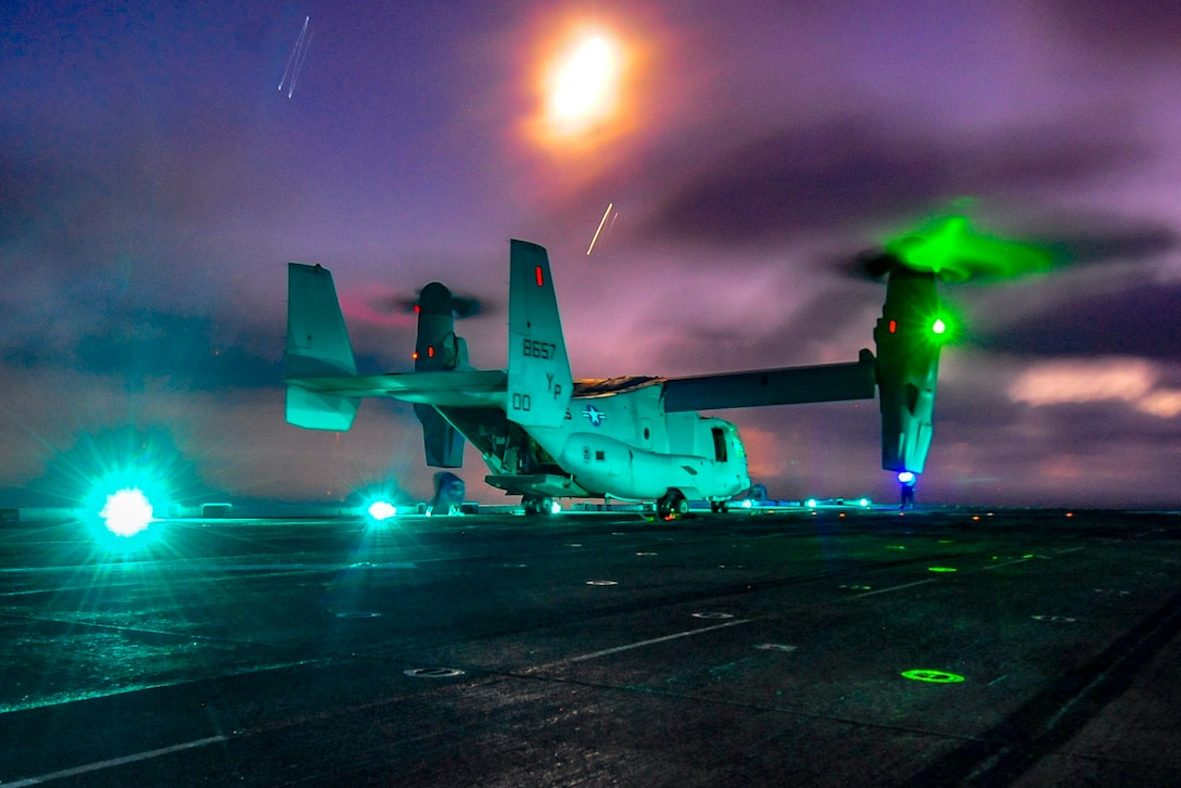 An Osprey prepares to take off from a naval ship.