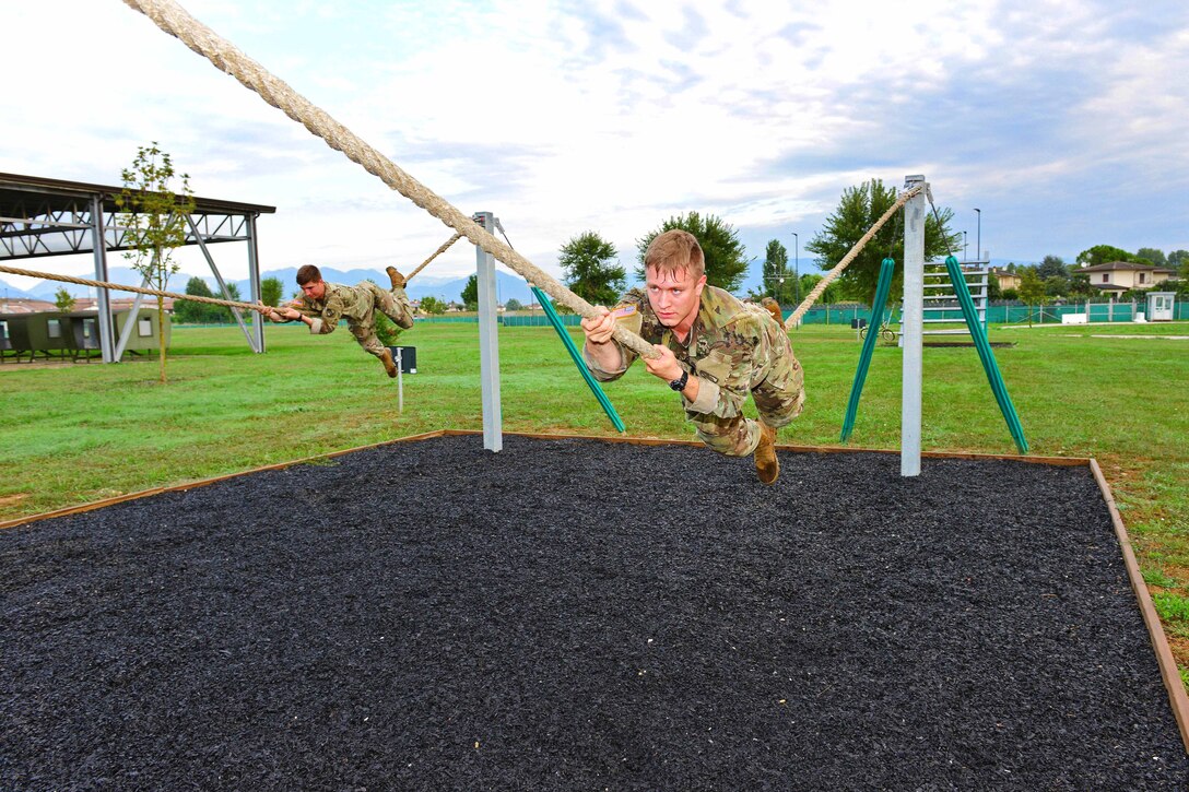 Soldiers navigate rope-bridge during the obstacle course.
