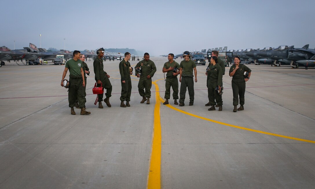 Marines with Marine Attack Squadron (VMA) 311 stand on the flight line after a successful foreign object damage walk during Exercise Northern Lightning at Volk Field Counterland Training Center, Camp Douglas, Wis. Aug. 16. Exercise Northern Lightning 2018 allows the Air Force, Marine Corps and Navy to strengthen interoperability between services and gives the different branches a greater understanding of aviation capabilities within a joint fighting force. (U.S. Marine Corps photo by Sgt. David Bickel)
