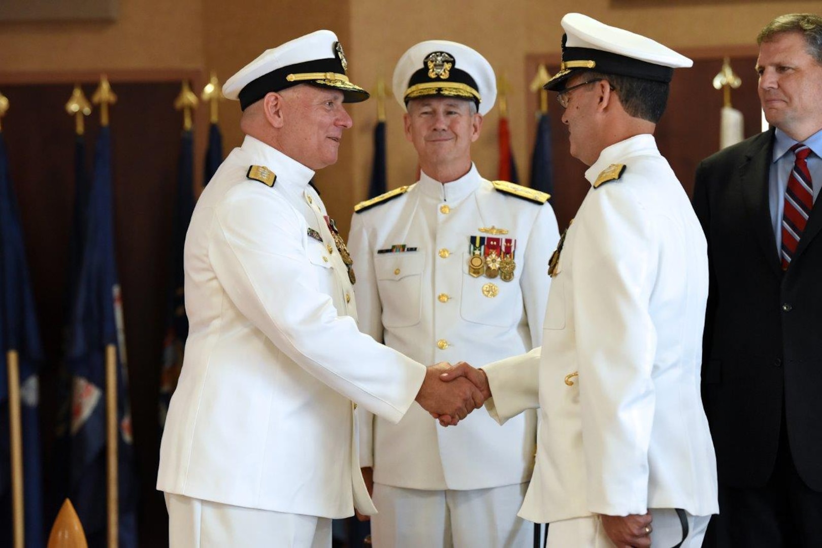 Rear Adm. Michael Jabaley congratulates Rear Adm. David Goggins on assuming duties as Program Executive Officer (PEO) for Submarines at a change of office ceremony at the Washington Navy Yard Aug. 17. PEO Submarines is responsible for developing, acquiring and modernizing the U.S. Navy's submarines and undersea systems.