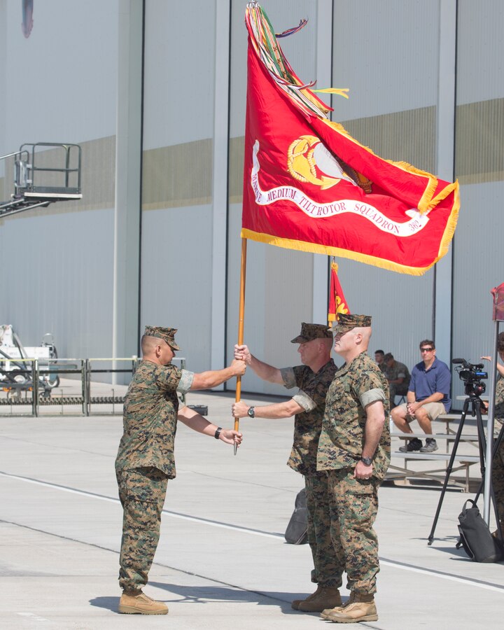 MARINE CORPS AIR STATION MIRAMAR, Calif. – Sgt. Maj. Abel T. Leal, left, sergeant major of Marine Aircraft Group (MAG) 16, 3rd Marine Aircraft Wing, passes the organizational colors to Col. Craig Leflore, commanding officer of MAG-16, during the Marine Medium Tiltrotor Squadron (VMM) 362 activation ceremony at Marine Corps Air Station Miramar, Calif., Aug. 17. The passing of the organizational colors signifies a formal transfer of authority and responsibility from one commanding officer to another. (U.S. Marine Corps photo by Lance Cpl. Juan Anaya)