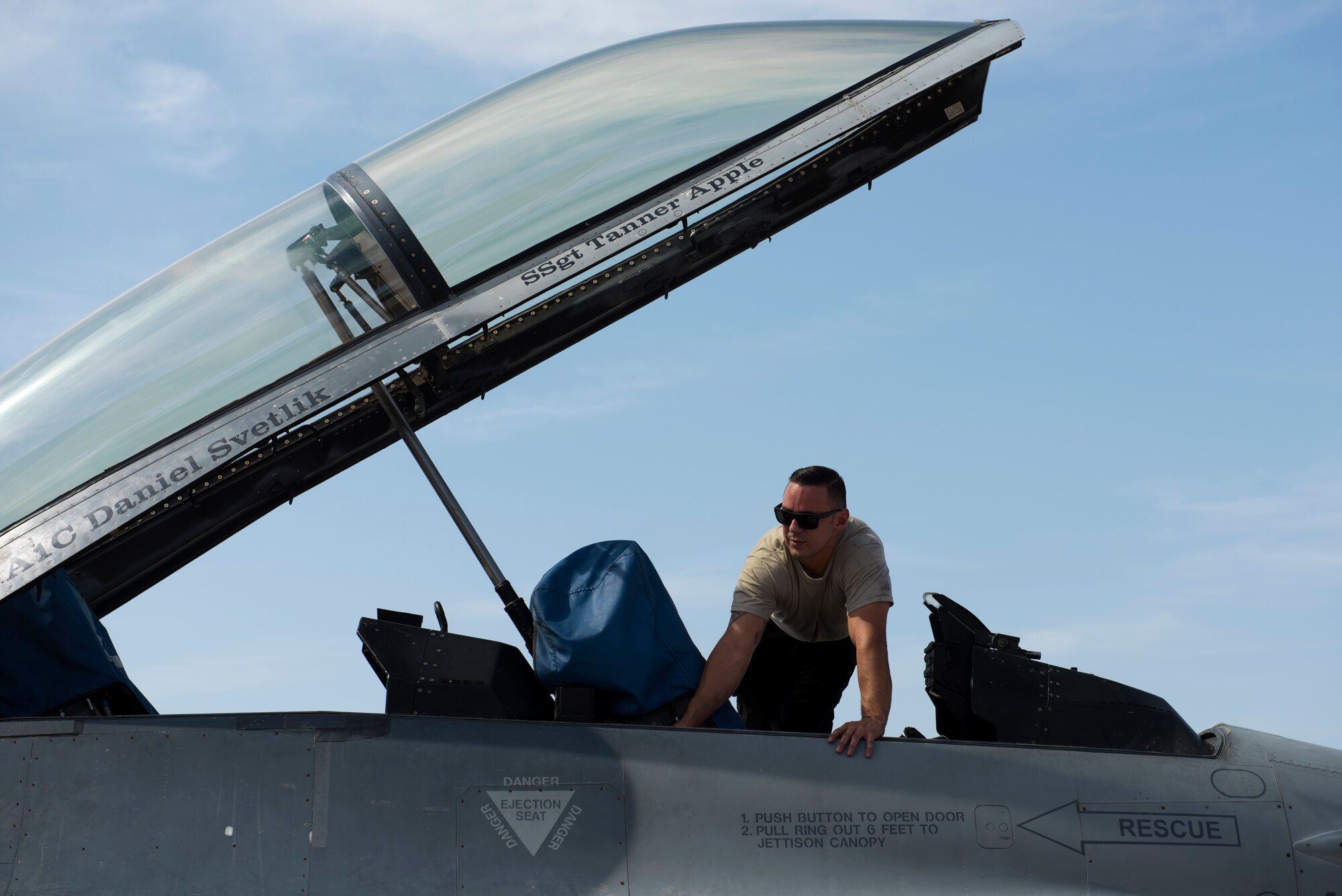 Staff Sgt. Tanner Apple, 309th Aircraft Maintenance Unit dedicated crew chief, inspects the cockpit of his F-16 Fighting Falcon, Aug. 20, 2018, at Luke Air Force Base, Ariz. Tanner was awarded the 2017 Thomas N. Barnes award for the best dedicated crew chief in the Air Force. (U.S. Air Force photo by Senior Airman Ridge Shan)
