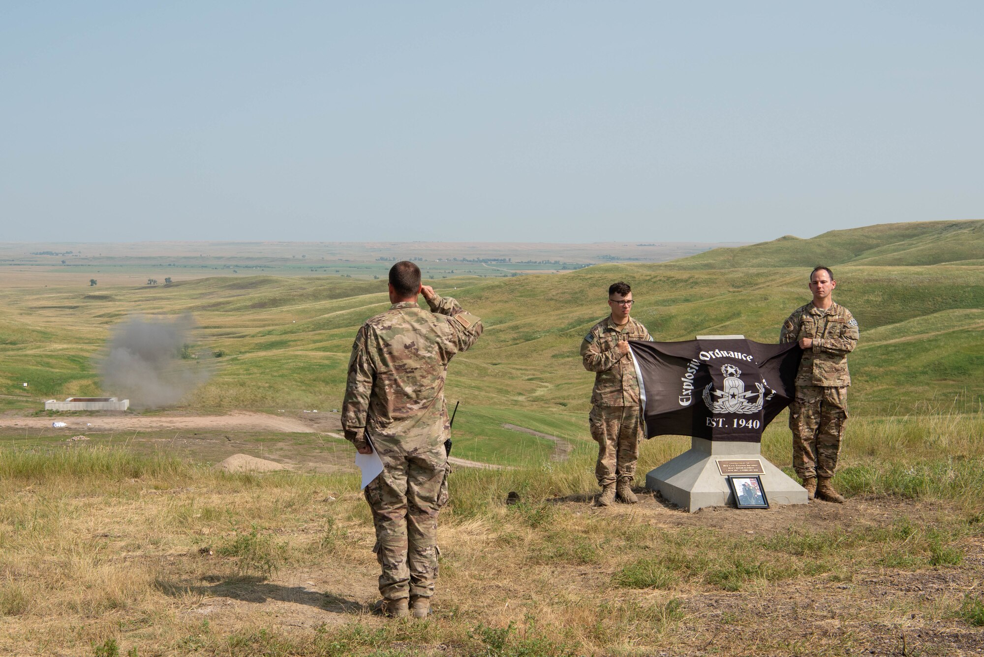 Staff Sgt. Edward Garwick watches a controlled detonation during an explosive ordnance disposal range dedication ceremony on Ellsworth Air Force Base, S.D., Aug. 17, 2018. The range was named in honor of Staff Sgt. Bryan D. Berky, an EOD technician deployed from Ellsworth AFB who was killed in action on Sept. 12, 2009, while serving in the western province of Farah, Afghanistan. Garwick is the 28th Civil Engineer Squadron noncommissioned officer in charge of the EOD training section. (U.S. Air Force photo by Tech. Sgt. Jette Carr)