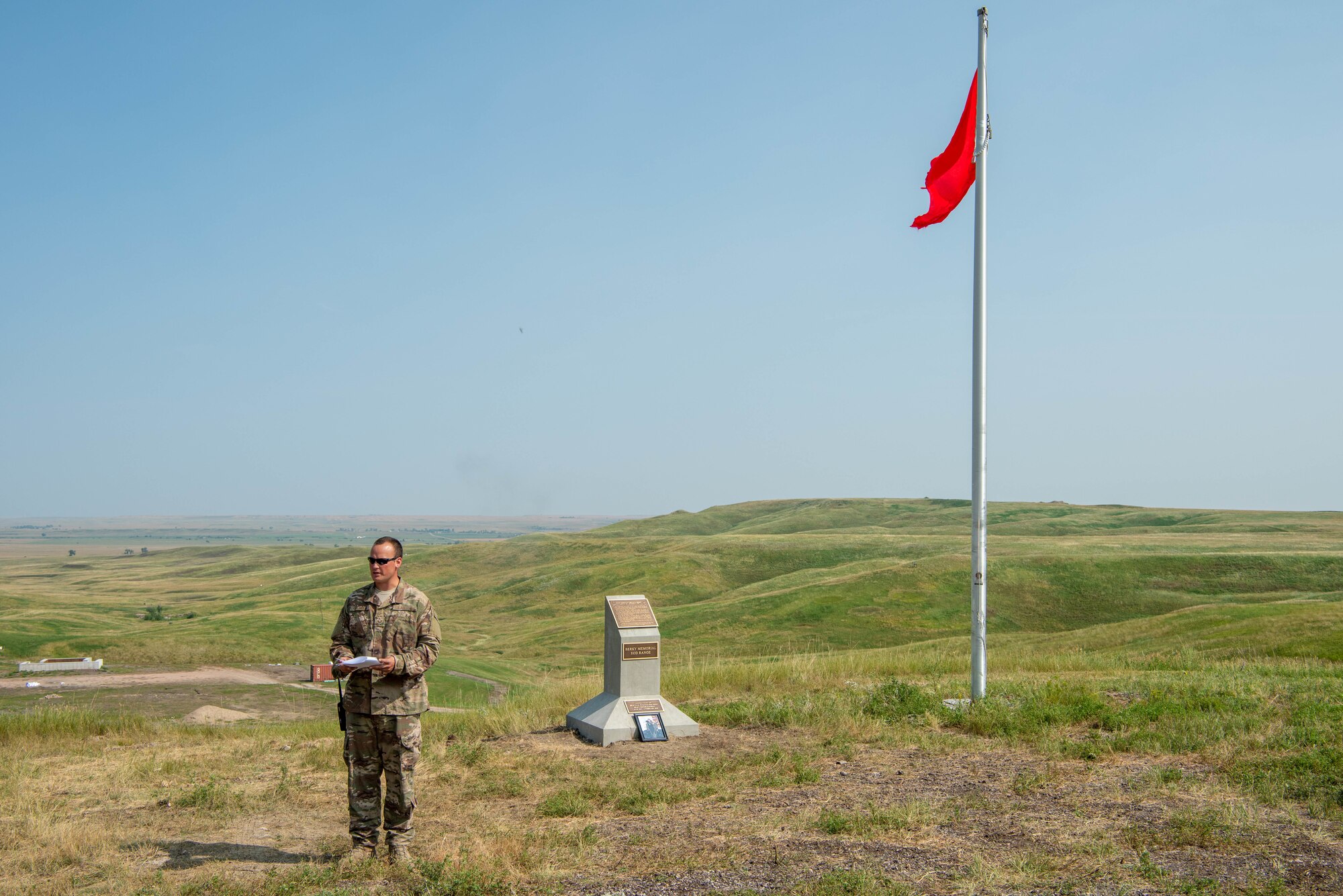 Staff Sgt. Edward Garwick speaks during an explosive ordnance disposal range dedication ceremony at Ellsworth Air Force Base, S.D., Aug. 17, 2018. The range was named in honor of Staff Sgt. Bryan D. Berky, an EOD technician deployed from Ellsworth AFB who was killed in action on Sept. 12, 2009, while serving in the western province of Farah, Afghanistan. Garwick is the 28th Civil Engineer Squadron noncommissioned officer in charge of the EOD training section. (U.S. Air Force photo by Tech. Sgt. Jette Carr)