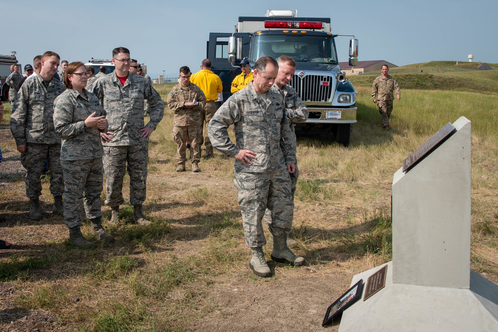 Brig. Gen. Eric Froehlich and Col. Eric Hresko read a plaque memorializing Staff Sgt. Bryan D. Berky following a range dedication in his honor at Ellsworth Air Force Base, S.D., Aug. 17, 2018. Berky, an explosive ordnance disposal technician deployed from Ellsworth AFB, was killed in action on Sept. 12, 2009, while serving in the western province of Farah, Afghanistan. Froehlich is the director of logistics, engineering and force protection at headquarters Air Force Global Strike Command at Barksdale AFB, La., and Hresko is the 28th Bomb Wing vice commander. (U.S. Air Force photo by Tech. Sgt. Jette Carr)