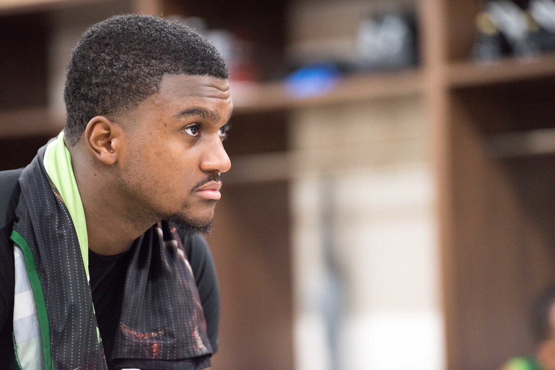 Myles Erkins, a Misawa Jets and 35th Force Support Squadron member, watches and listens while his coach and teammates discuss their pregame strategies for coming out on top of the Aomori Wat’s before the exhibition game at the Misawa International Sports Center in Misawa City, Japan, Aug. 18, 2018. The Wat’s proved more difficult a competitor but the Jets kept up the pace into halftime with the Wat’s leading 46-35. (U.S. Air Force photo by Tech. Sgt. Benjamin W. Stratton)