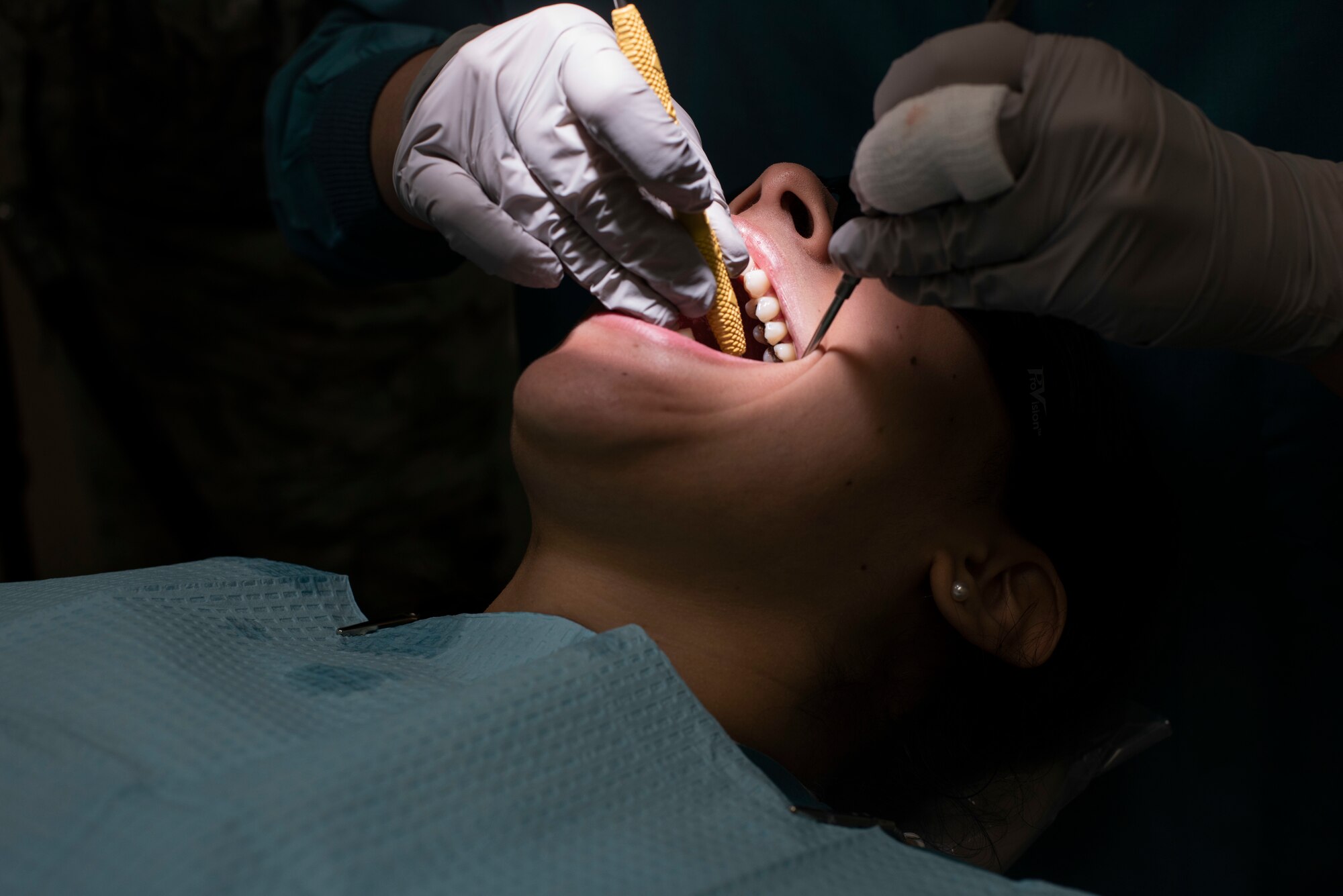 U.S. Air Force Senior Airman Courtney Lott performs a routine dental cleaning on Airman 1st Class Ana Karen Lemieux, both 35th Dental Squadron dental technicians, at Misawa Air Base, Japan, Aug. 17, 2018. The Ohio native decided to follow in the footsteps of her mother and join the U.S. Air Force post high school graduation, pursuing a career in the medical field. (U.S. Air Force photo by Airman 1st Class Collette Brooks)