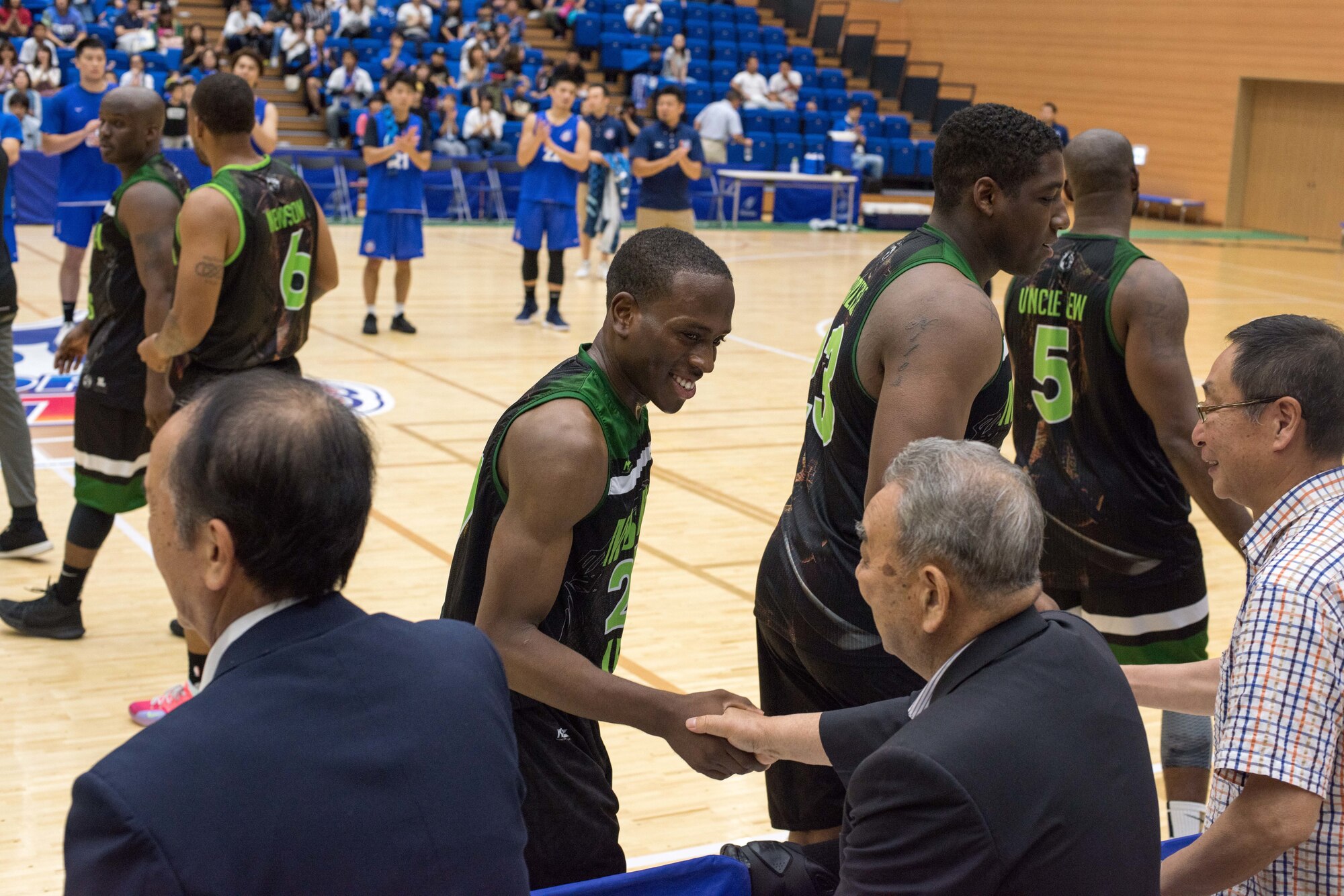 U.S. Air Force Airman Deshaan Campbell, a Misawa Jets member and 35th Logistics Readiness Squadron air transportation apprentice, shakes hands with Misawa City Mayor Kazumasa Taneichi following the Aomori Wat’s and Misawa Jets exhibition game at the Misawa International Sports Center in Misawa City, Japan, Aug. 18, 2018. Although the final score resulted in a Wat’s win, 104-75, the Jets’ coach said his team knew the game was more about building relations with the Japanese community and embracing the city’s, “co-existence, co-prosperity” approach to Misawa Air Base. (U.S. Air Force photo by Tech. Sgt. Benjamin W. Stratton)