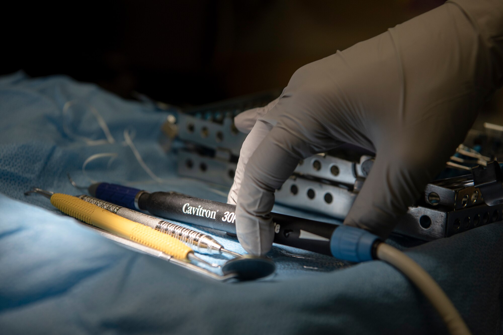U.S. Air Force Senior Airman Courtney Lott, a 35th Dental Squadron dental technician, reaches for a Cavitron Steri-Mate Detachable Serializable Handpiece before performing a dental cleaning at Misawa Air Base, Japan, Aug. 17, 2018. Lott a single mother, said being in the service gives her much more than just trade skills in dentistry, but also gives her and her son financial stability. (U.S. Air Force photo by Airman 1st Class Collette Brooks)