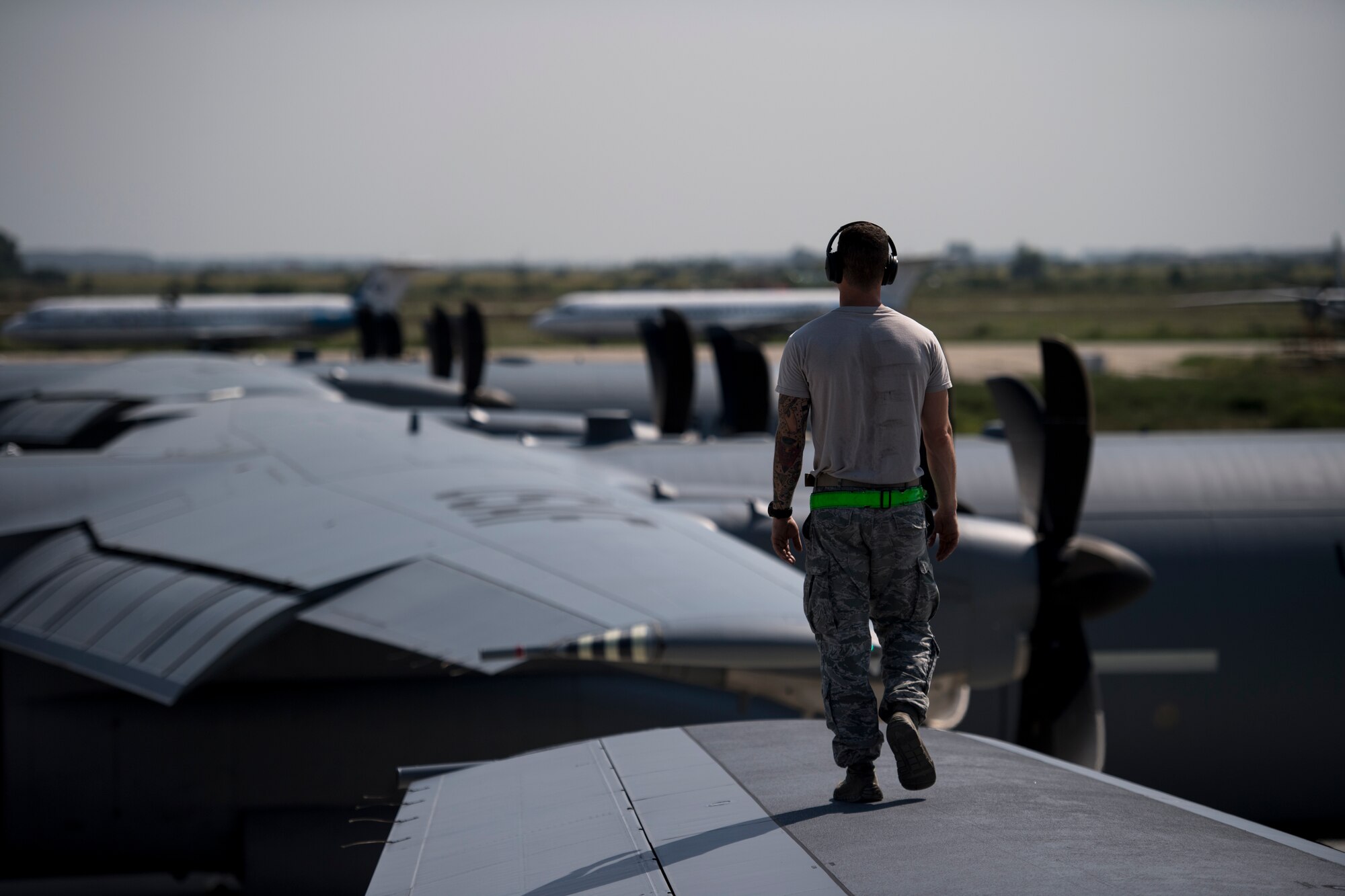 A U.S. Air Force Airman assigned to the 86th Aircraft Maintenance Squadron, walks down the wing of a C-130J Super Hercules aircraft assigned to the 37th Airlift Squadron, during a pre-flight inspection at Otopeni Air Base, Romania, Aug. 21, 2018. The C-130Js were flown over Romania as part of Carpathian Summer 2018, an annual exercise between the U.S. Air Force and Romanian air force. (U.S. Air Force photo by Senior Airman Devin Boyer)
