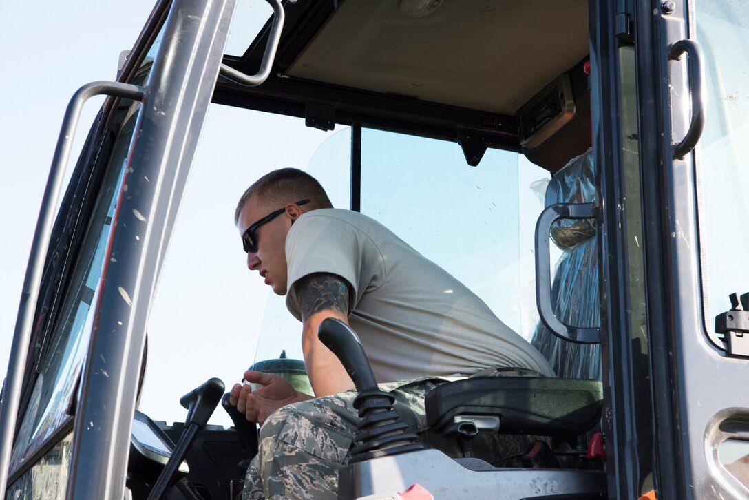 U.S. Air Force Airman 1st Class Gunner Gearhart, 8th Civil Engineer Squadron pavements and equipment operator, clears debris from a storm drain in preparation for Typhoon Soulik on Aug. 22, 2018 at Kunsan Air Base, Republic of Korea. As Typhoon Soulik approaches the Korean peninsula, the Airmen assigned to the 8th Fighter Wing prepare the air base to weather the approaching storm. (U.S. Air Force photo by Staff Sgt. Levi R. Rowse)