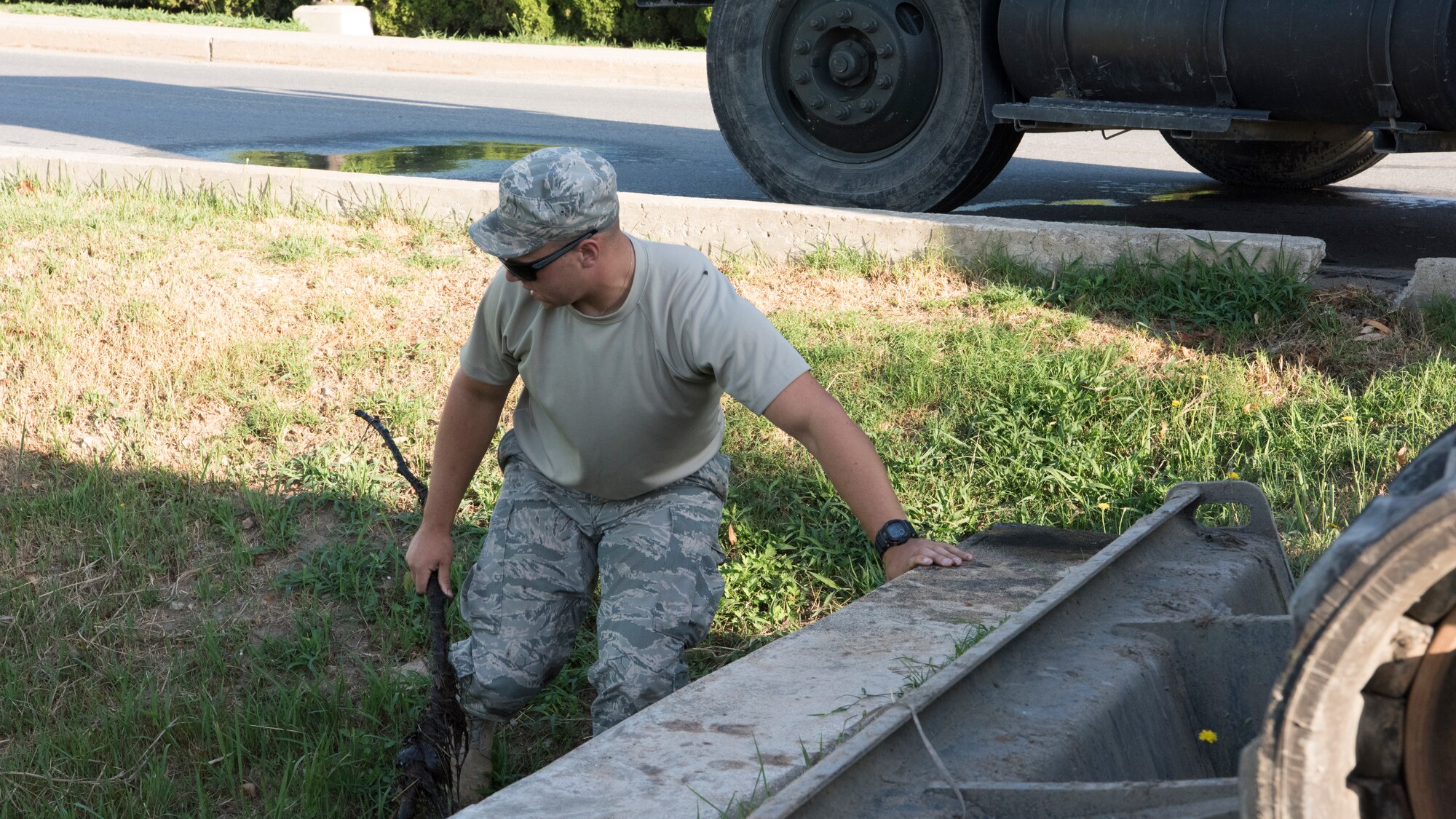 U.S. Air Force Senior Airman Kyle Gibson, 8th Civil Engineer Squadron pavements and equipment operator, removes debris from a storm drain in preparation for Typhoon Soulik at Kunsan Air Base, Republic of Korea, Aug. 22, 2018. Airmen from the 8th Fighter Wing cleaned-up loose items, filled sand bags, and took other preparatory actions as Typhoon Soulik approaches the Korean peninsula. (U.S. Air Force photo by Staff Sgt. Levi R. Rowse)