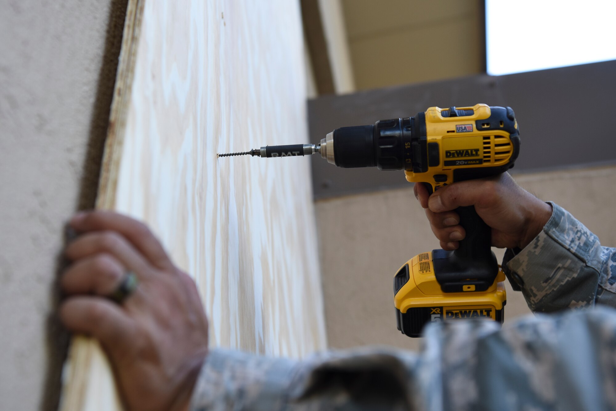 U.S. Air Force Tech. Sgt. Darlwin Langit, 8th Civil Engineer Squadron structural noncommissioned officer in charge, drills a sheet of plywood into place while boarding up a Kunsan Air Base Chapel window at Kunsan Air Base, Republic of Korea, Aug. 22, 2018. Airmen from the 8th Fighter Wing cleaned-up loose items, filled sand bags, and took other preparatory actions as Typhoon Soulik approaches the Korean peninsula.  (U.S. Air Force photo by Senior Airman Savannah L. Waters)