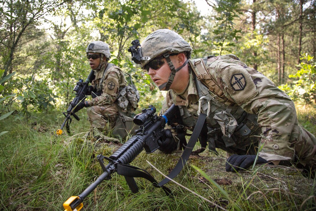 A soldier prepares to move out to a new firing position.