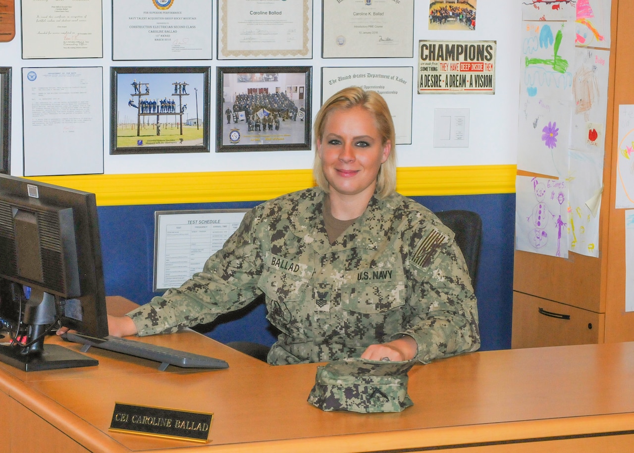 Navy Petty Officer 1st Class Caroline Ballad, a recruiter, works at her desk processing future sailor’s paperwork for entering the Navy at Navy Talent Acquisition Group Rocky Mountain-Utah Division, Taylorsville, Utah, Aug. 10, 2018. Navy photo by Petty Officer 3rd Class Zachary S. Eshleman