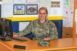 Navy Petty Officer 1st Class Caroline Ballad, a recruiter, works at her desk processing future sailorâ€™s paperwork for entering the Navy at Navy Talent Acquisition Group Rocky Mountain-Utah Division, Taylorsville, Utah, Aug. 10, 2018. Navy photo by Petty Officer 3rd Class Zachary S. Eshleman