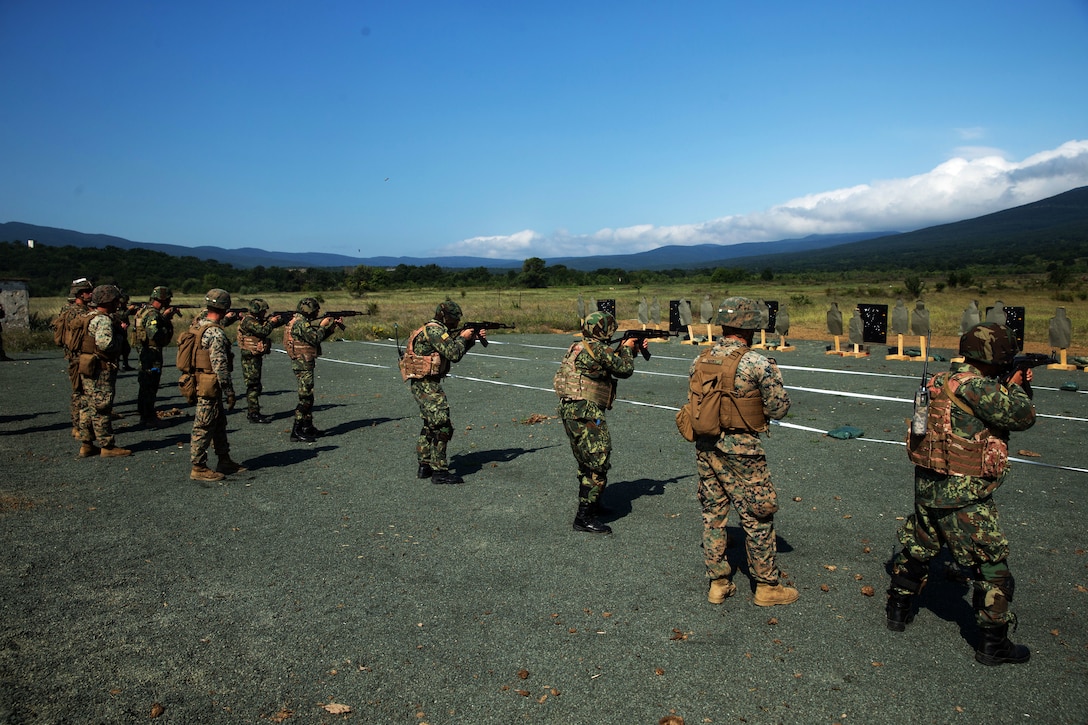 Marines watch as members of the Albanian armed forces participate in the combat marksmanship program.