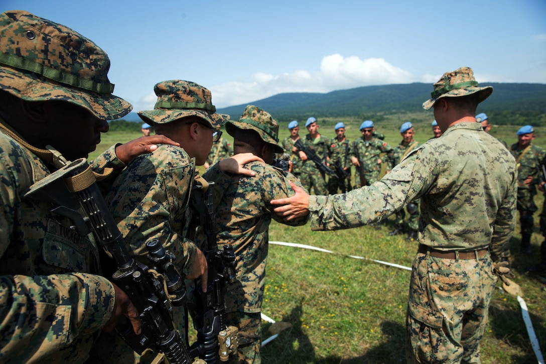 U.S. Marines demonstrate house clearing techniques as members of the Albanian armed forces look on during Exercise Platinum Lion 18.