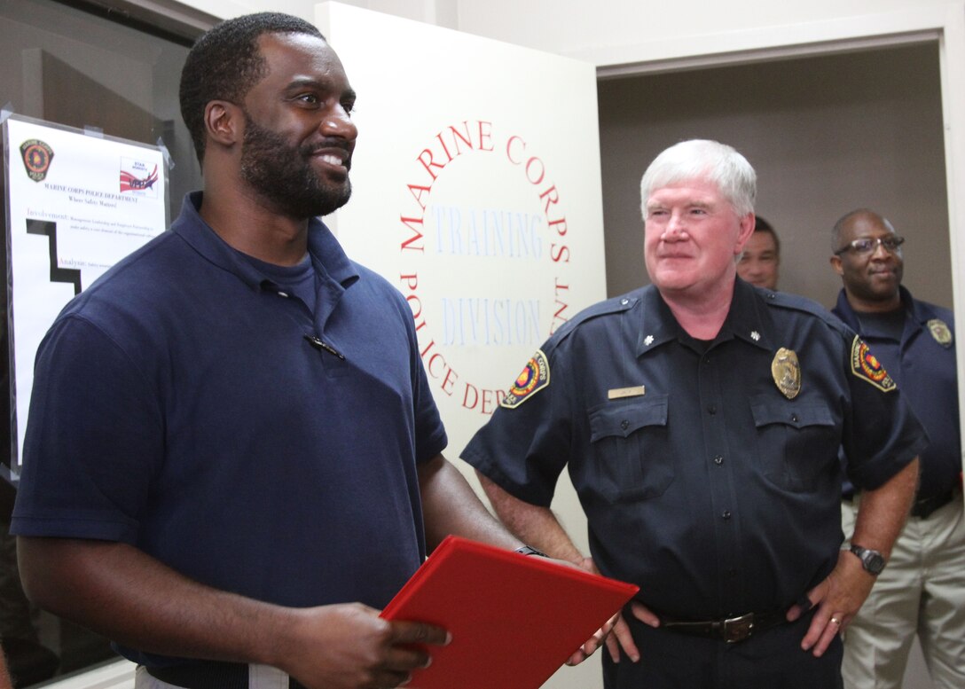 Marine Corps Police Department officer Willie Hall was awarded a certificate of commendation, August 21. Hall prevented a potential tragedy while responding to a house fire. Hall's dedicated attention to duty, not only saved lives but directly impacted the safety and security of neighboring residents and their families. (U.S. Marine Corps photo by Re-Essa Buckels)