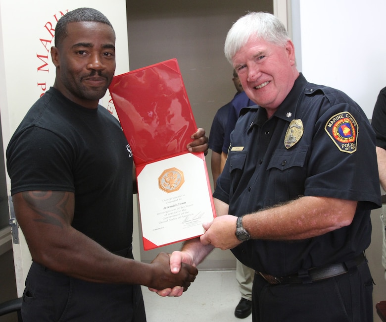 Marine Corps Logistics Base Albany Police Department Chief Randy Jack (right) presented a 10-year length of service award to MCPD officer Jeremiah Fenn (left), August 21. (U.S. Marine Corps photo by Re-Essa Buckels)