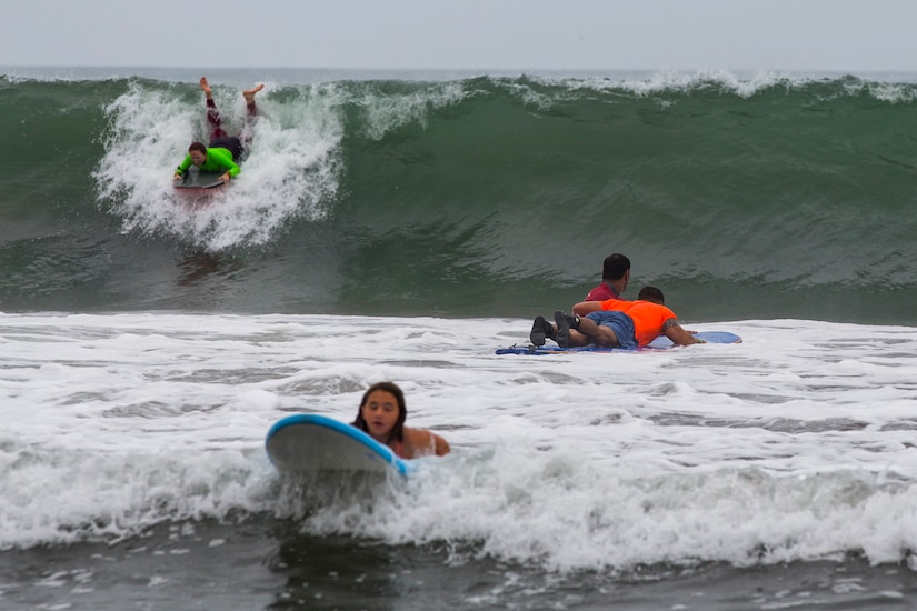 Recovering service members, veterans, volunteers and their loved ones surf during the 12th Annual Operation Amped Surf Camp at San Onofre Beach at Marine Corps Base Camp Pendleton, California, Aug. 18, 2018. Operation Amped holds a surf camp for wounded, ill or injured service members at San Onofre Beach once a year.