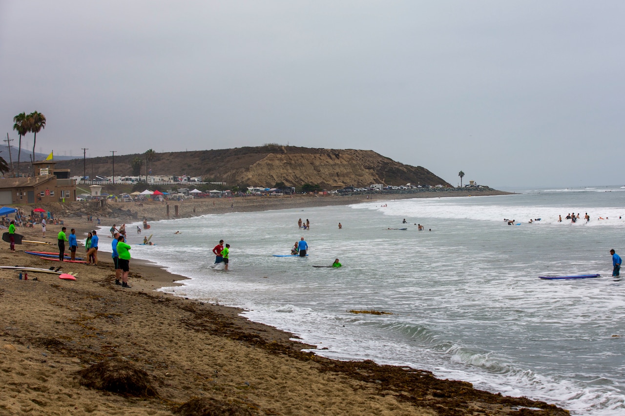 Recovering service members, veterans, volunteers and their loved ones prepare to surf during the 12th Annual Operation Amped Surf Camp at San Onofre Beach at Marine Corps Base Camp Pendleton, California, Aug. 18, 2018. Thirteen wounded, ill or injured service members attended the three-day event allowing the wounded warrior community a recreational outlet designed to aid in their recovery.