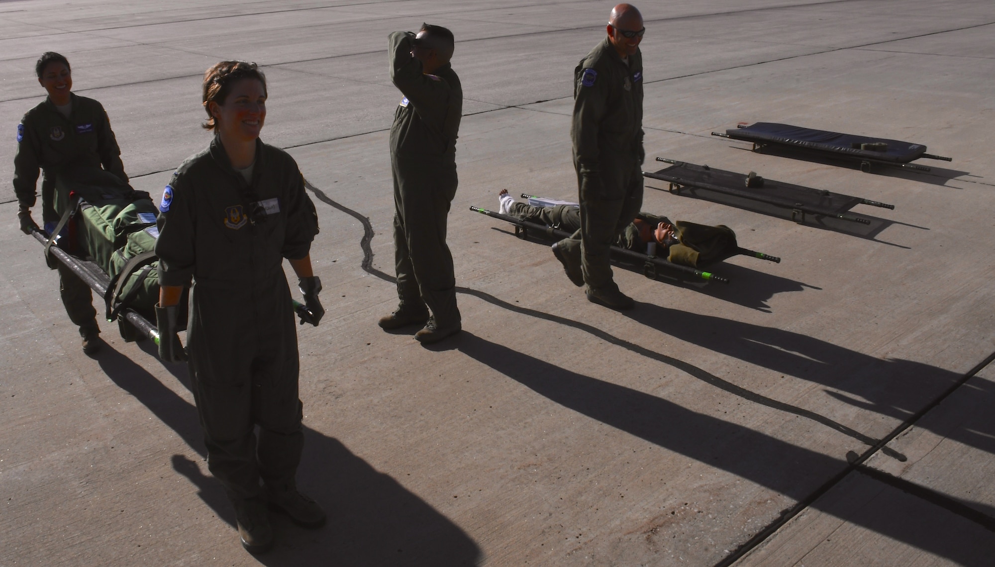 The 932nd Airlift Wing's, 932nd Aeromedical Evacuation Squadron medical members load up gear for an early morning flight, as shadows stretch across the runway.  Members make final arrangements to carry medical equipment up a ramp, as they work together with ground crew, preparing to fly with "simulated patients" during a training flight, July 21, 2018 at Scott Air Force Base, Ill. The AES trained alongside fellow nurses and medical technicians on a multi day flight aboard a C-130 aircraft visiting from the 910th Airlift Wing of Youngstown, Ohio. The 932nd Airlift Wing is a 22nd Air Force unit, under the Air Force Reserve Command, and is located at Scott Air Force Base, Ill. (U.S. Air Force photos by Lt. Col. Stan Paregien)