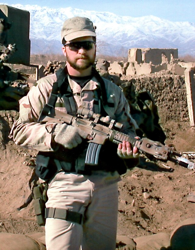 One person standing with a mountainous background.