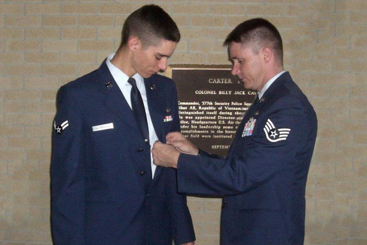 Air Force Staff Sgt. Marco Kalkbrenner pins Airman 1st Class Ivan Kalkbrenner, his younger brother, upon completion of technical training for security forces. Marco pinned his brother in the same spot his father pinned him to continue the tradition.