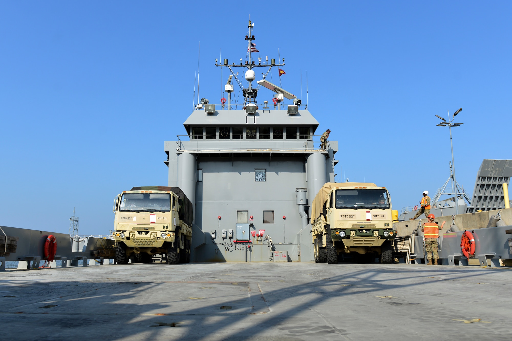 U.S. Army Soldiers assigned to the 7th Transportation Brigade (Expeditionary) load vehicles onto a Landing Craft Utility vessel during a Joint Task Force Port Opening familiarization training at Joint Base Langley-Eustis, Va., Aug. 17, 2018.