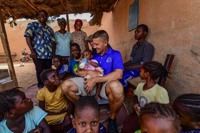 Air Force Col. Trey Rawls, 435th Air Expeditionary Wing commander, holds a baby at an orphanage in Agadez, Niger.