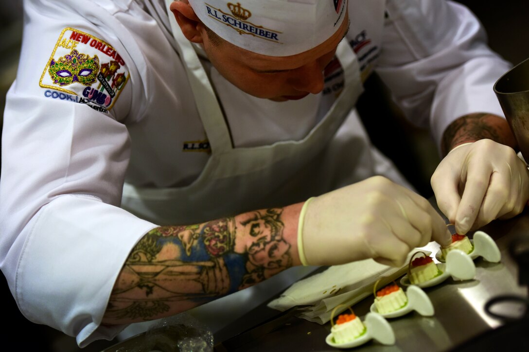 A Coast Guard member competes in the final round of the American Culinary Federation Student Team Championships.