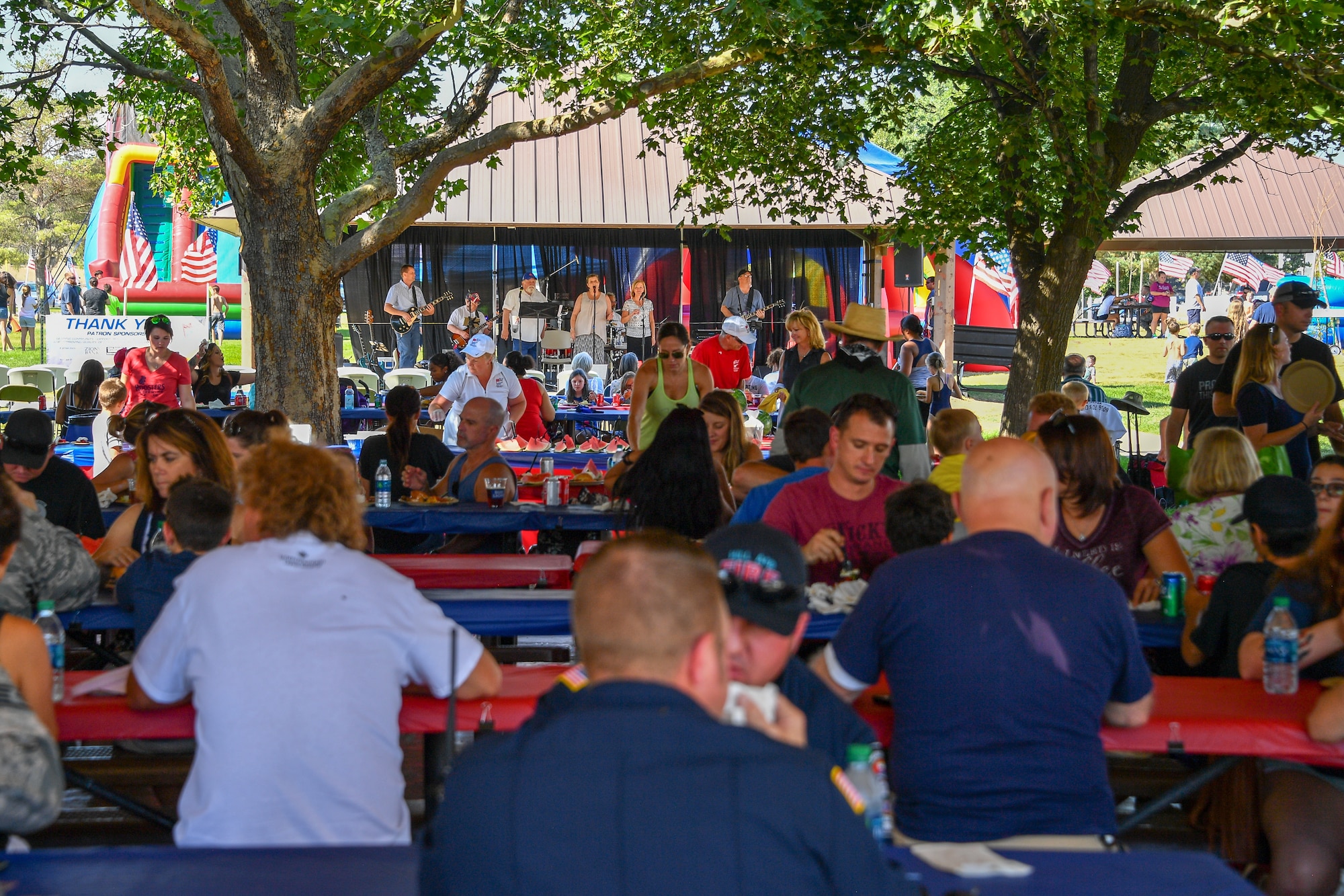 Families listen to live entertainment during the Salute Picnic Aug. 17, 2018, at Hill Air Force Base, Utah. This was the 18th year the Top of Utah Military Affairs Committee has sponsored the picnic. (U.S. Air Force photo by R. Nial Bradshaw)
