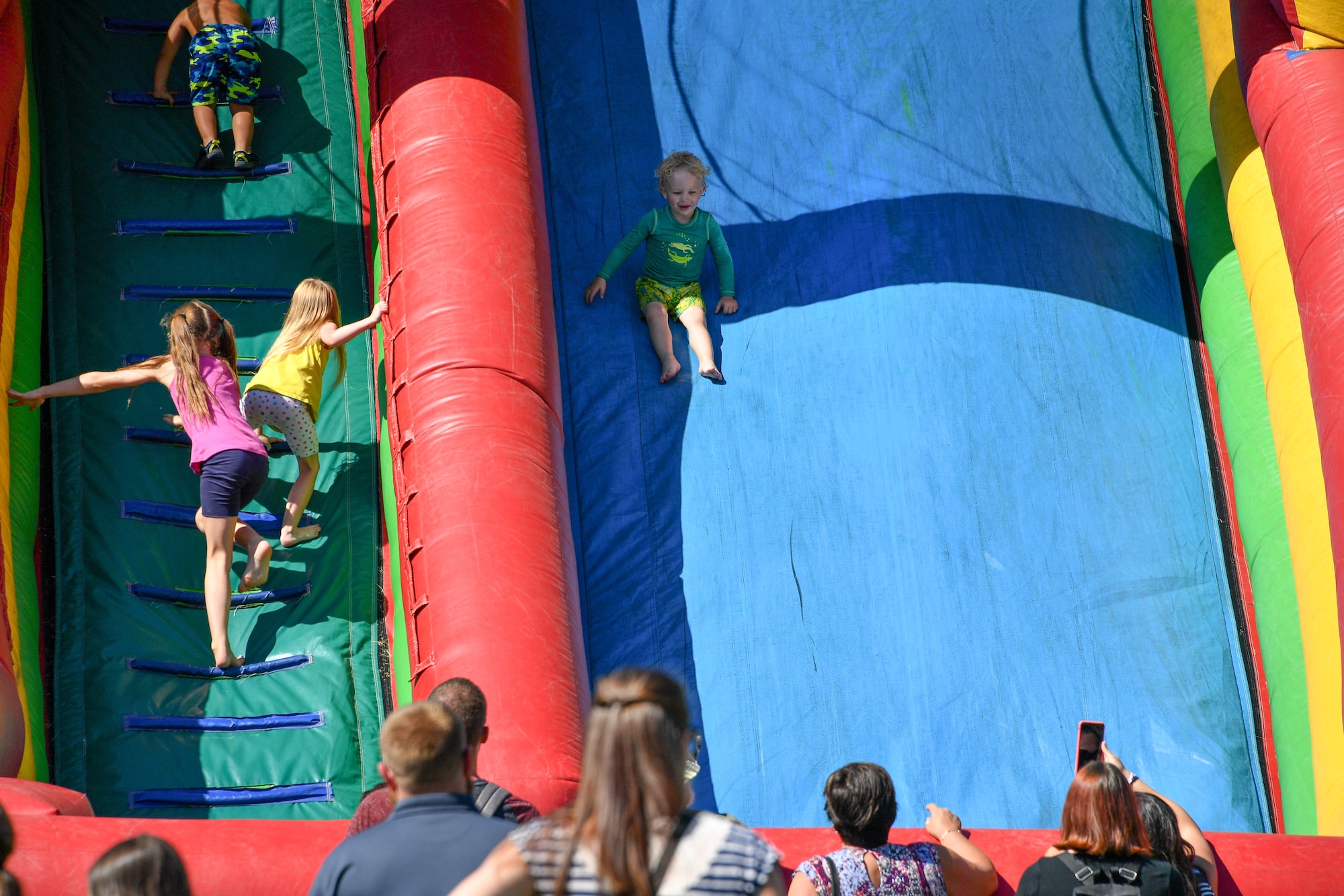 Michael Quinby descends an inflatable slide during the 18th annual Salute Picnic Aug. 17, 2018, at Hill Air Force Base, Utah. Sponsored by the Top of Utah Military Affairs Committee, this year's event included activities such as wet and dry inflatables, a rock climbing wall, face painting and a mechanical bull. (U.S. Air Force photo by R. Nial Bradshaw)