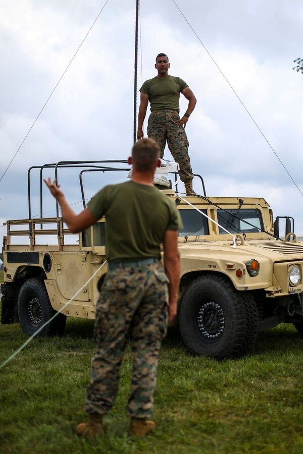 Marines with Marine Aircraft Group (MAG) 13 work on communications equipment during Exercise Northern Lightning at Volk Field Counterland Training Center, Camp Douglas, Wis. Aug. 16. Exercise Northern Lightning 2018 allows the Air Force, Marine Corps and Navy to strengthen interoperability between services and gives the different branches a greater understanding of aviation capabilities within a joint fighting force. (U.S. Marine Corps photo by Sgt. David Bickel)