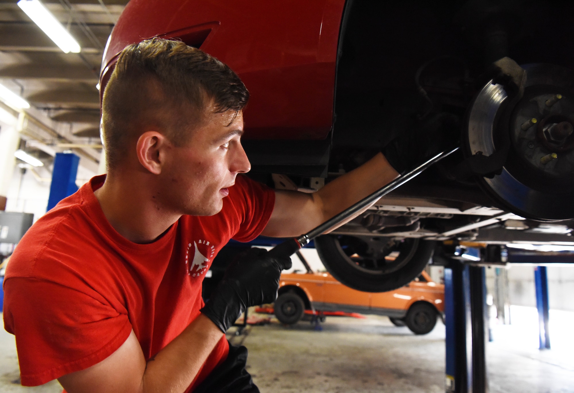 Senior Airman Chance Young, a 28th Maintenance Group squadron load crew member, replaces brakes in the auto hobby shop at Ellsworth Air Force Base, S.D., Aug. 15, 2018. The mechanics at the hobby shop are here to help Airmen and their families with their automotive repair needs and to help car enthusiasts with their projects. (U.S. Air Force Photo by Airman 1st Class Thomas Karol)