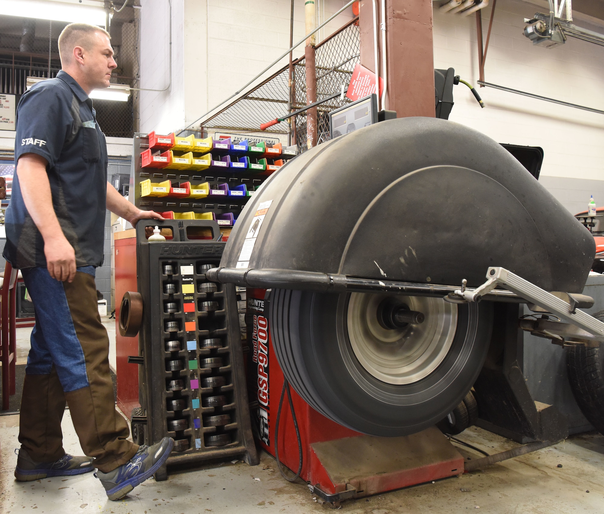 Chadwick Eldridge, a mechanics assistant at the auto hobby shop, performs a tire rotation at Ellsworth Air Force Base, S.D., Aug. 15, 2018. The mechanics at the hobby shop are here to help Airmen and their families with their automotive repair needs and to help car enthusiasts with their projects. (U.S. Air Force Photo by Airman 1st Class Thomas Karol)