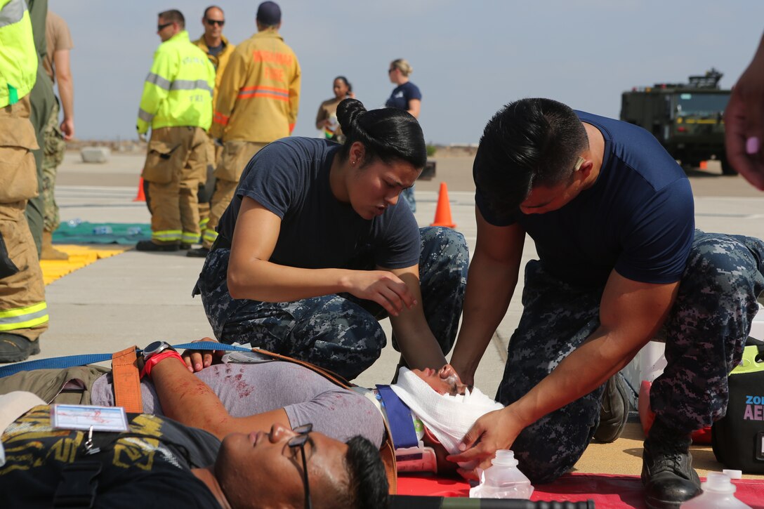 Navy corpsman with Marine Corps Air Station Miramar’s Branch Medical Clinic conducts triage training and prepares a victim for transportation during an exercise at MCAS Miramar, Aug 16. 2018. Emergency response exercises are conducted to rehearse response times, validate existing standard operating procedures, fulfill annual training requirements and validate the effectiveness of MCAS Miramar emergency services. (U.S. Marine Corps photo by Sgt. Daniel Auvert.)