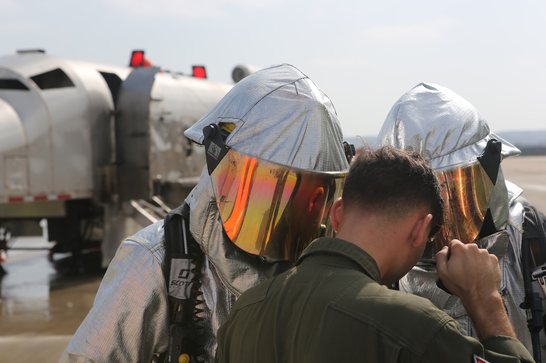 Marines with Marine Corps Air Station Miramar Aircraft Rescue and Fire Fighting give a report on a mobile burn unit during an exercise at MCAS Miramar, Aug 16. 2018. Emergency response exercises are conducted to rehearse response times, validate existing standard operating procedures, annual training requirements and validate the effectiveness of MCAS Miramar emergency services. (U.S. Marine Corps photo by Sgt Daniel Auvert.)