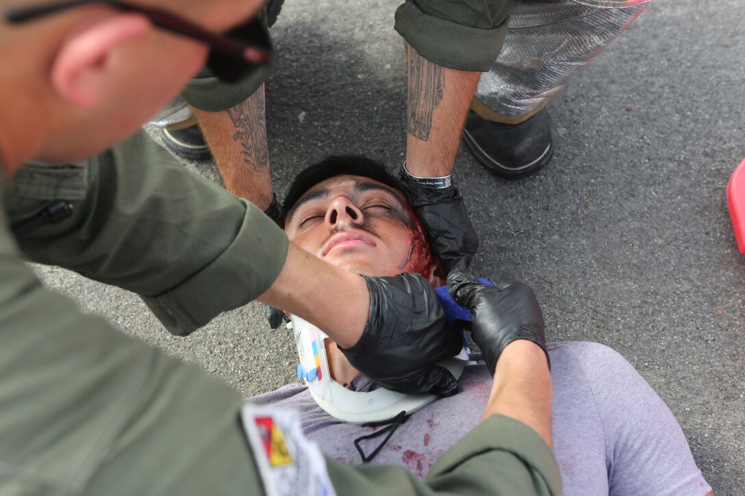 Marines with Marine Corps Air Station Aircraft Rescue and Fire Fighting conducts triage training on a victim during an exercise at MCAS Miramar, Aug 16. 2018. Emergency response exercises are conducted to rehearse response times, validate existing standard operating procedures, fulfill annual training requirements and validate the effectiveness of MCAS Miramar emergency services. (U.S. Marine Corps photo by Daniel Auvert.)