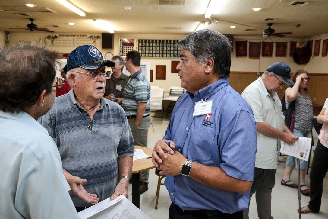 Harry Hendler, a U.S. Army Corps of Engineers Los Angeles District Formerly Used Defense Sites project manager, speaks with community members during an open house Aug. 20. A remedial investigation and feasibility study will determine if additional clearance activities are necessary. The site includes about 284 residential properties and parcels, located on Tommie Drive, East Packard, Lass, East Snavely, East Thompson, East Lum, East Ryan, East Hearne, East Devlin, East Shaeffer, East John L and Northfield avenues.