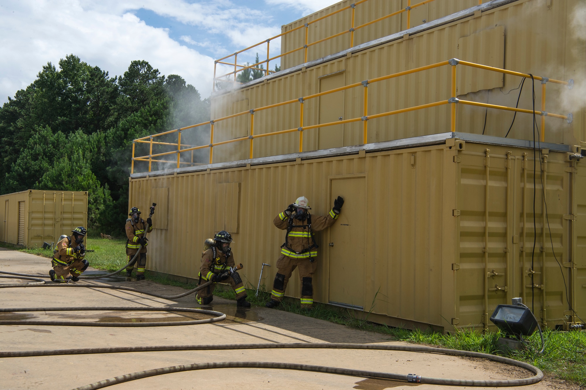 U.S. Air Force firefighters check for the heat source of a simulated three-story building fire as a part of Patriot Warrior 2018 at Dobbins Air Reserve Base, Georgia, August 17, 2018. Firefighters with the 624th Civil Engineer Squadron from Joint Base Pearl Harbor-Hickam, Hawaii, 446th CES from Joint Base Lewis-McChord, Washington and the 514th CES from Joint Base McGuire-Dix-Lakehurst, New Jersey, trained together as one team. Patriot Warrior is an Air Force Reserve exercise designed to prepare Reserve Citizen Airmen for world-wide deployments and provides knowledge and experience to strengthen home station training programs. (Air Force photo by Master Sgt. Theanne Herrmann)