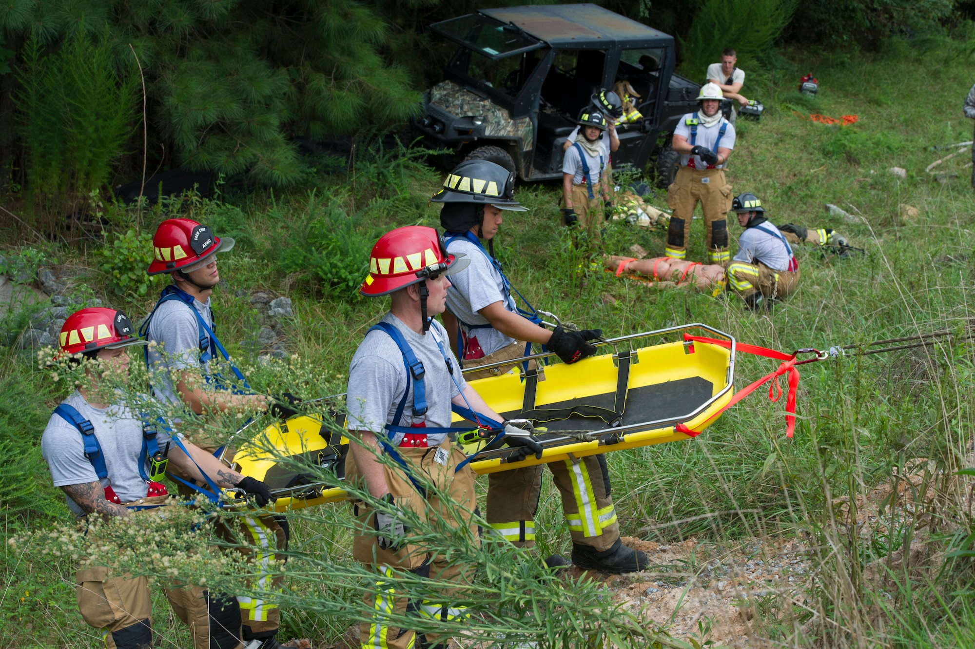 Firefighters with the 446th Civil Engineer Squadron from Joint Base Lewis-McChord, Washington, 514th CES, Joint Base McGuire-Dix-Lakehurst and the 624th CES from Joint Base Pearl Harbor-Hickam, Hawaii, remove a patient from a simulated roll over accident during a low angle rescue operation as a part of Patriot Warrior 2018 at Dobbins Air Reserve Base, Georgia, Aug. 17, 2018. Patriot Warrior is an Air Force Reserve exercise designed to prepare Reserve Citizen Airmen for world-wide deployments and provides knowledge and experience to strengthen home station training programs. (U.S. Air Force photo by Master Sgt. Theanne Herrmann)